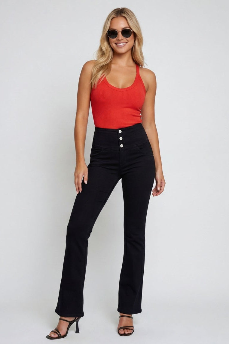 Woman wearing black pants with a red top on a white background