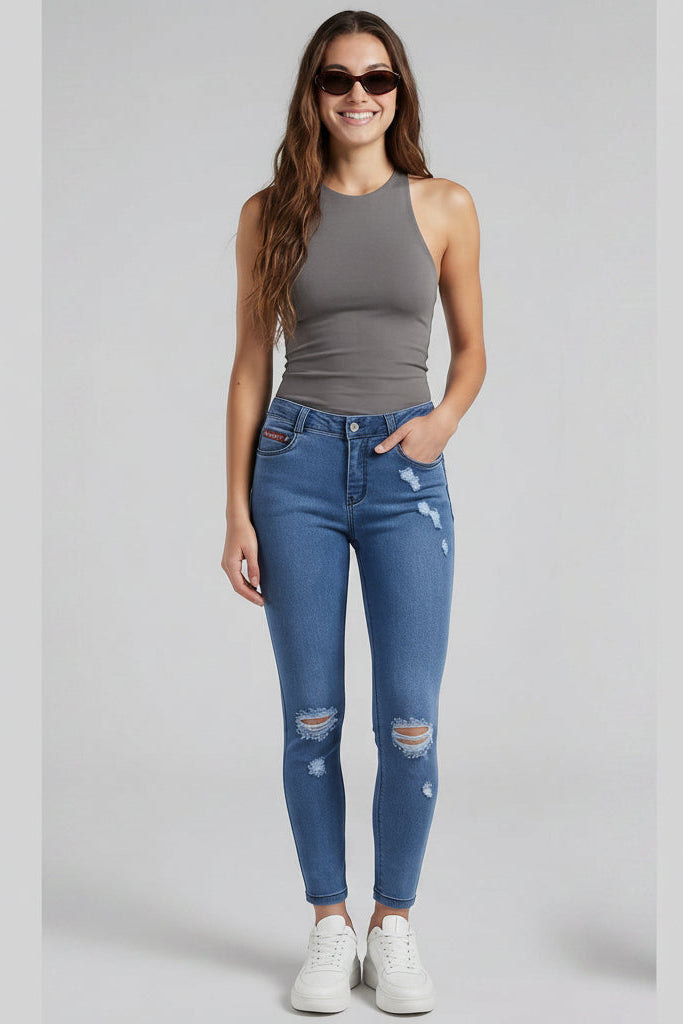 Woman modeling blue jeans from front, back, and side views on a gray background.
