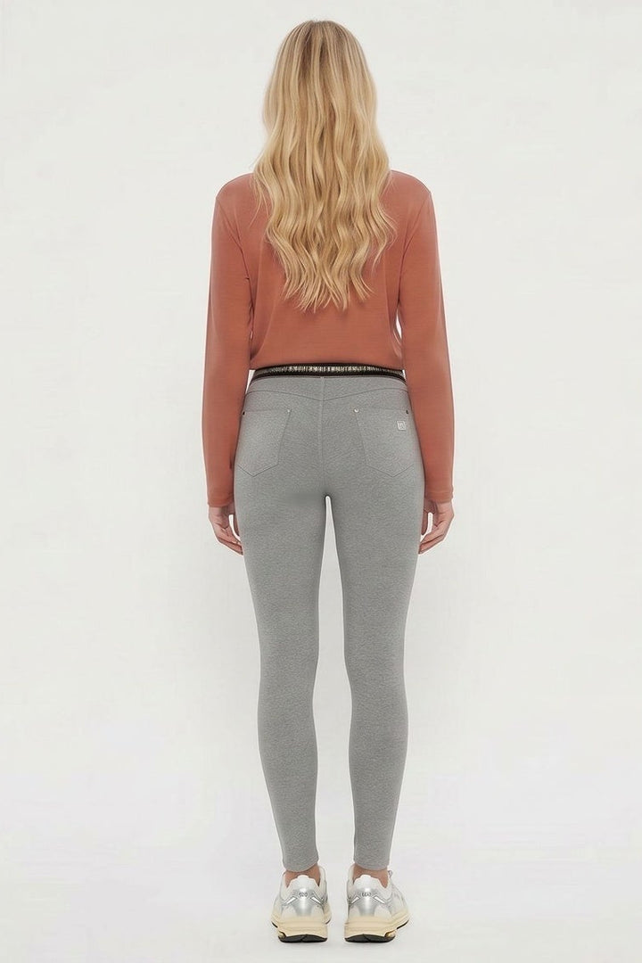 Woman wearing gray leggings and a rust-colored long-sleeve top, shown from front and back on a white background.
