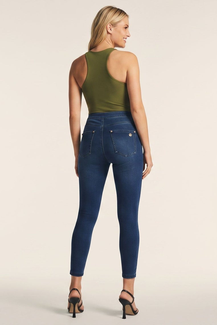 Woman wearing blue jeans and a green top, shown from front and back on a beige background