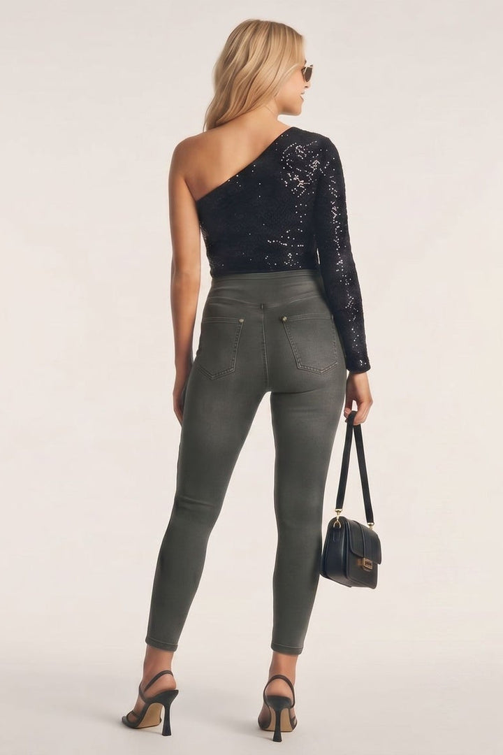 Woman modeling a black one-shoulder top and gray pants from different angles on a white background.