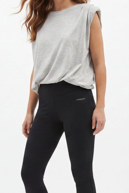 Woman wearing black leggings and a white top, shown from front and back on a white background.