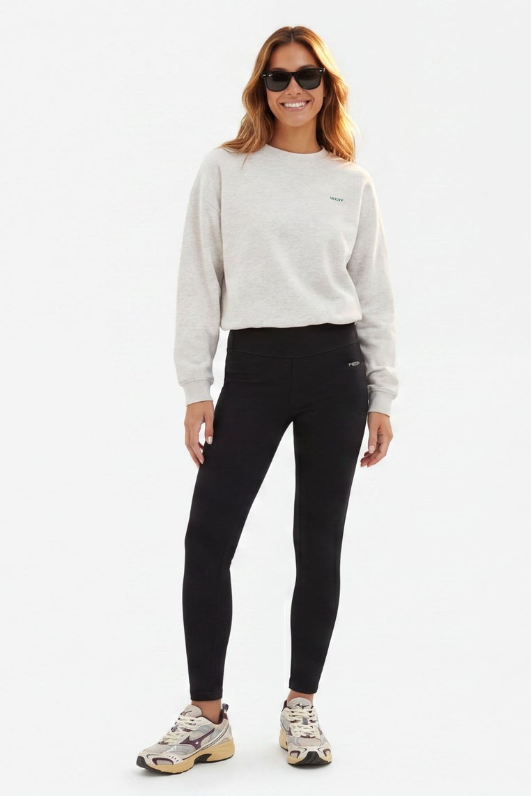 Woman wearing a white sweatshirt and black leggings from different angles on a white background