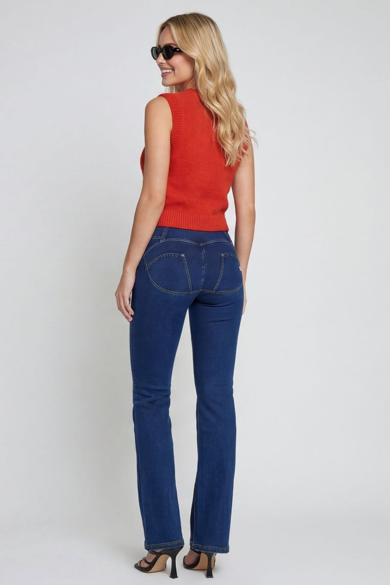 Woman wearing a red top and blue jeans on a white background