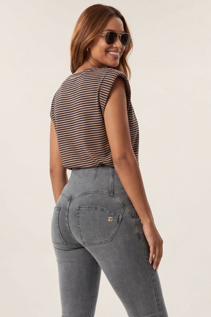 Woman wearing a striped top and high-waisted jeans, shown from front and side views.