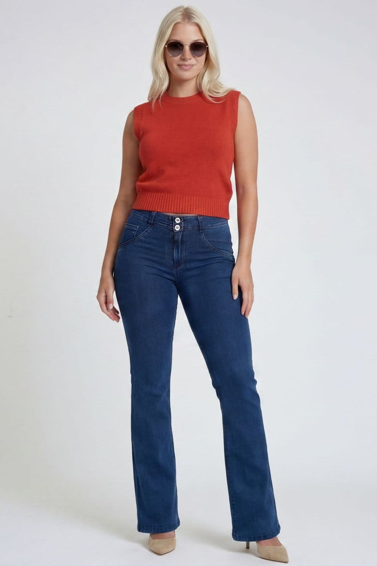 Woman wearing blue jeans and a red top on a white background