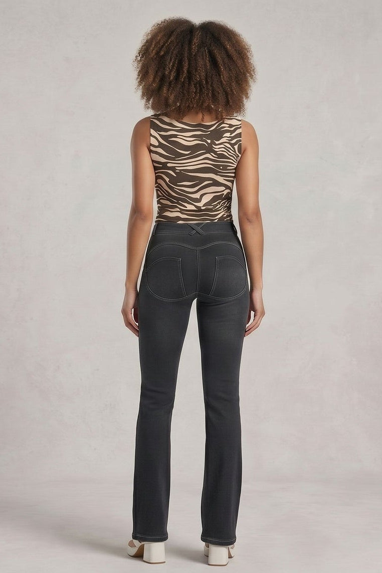 Woman wearing a zebra print top and dark jeans, shown from front and back on a plain background.