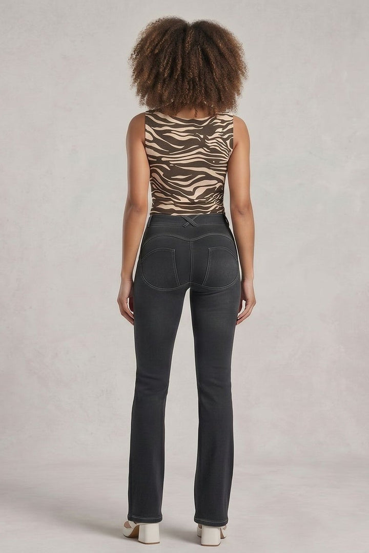 Woman wearing a zebra print top and dark jeans, shown from front and back on a plain background.