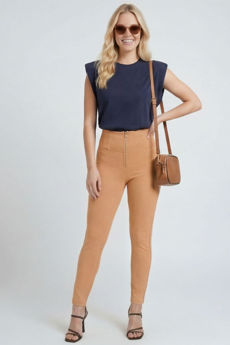 Woman wearing a navy top and tan pants, shown from front and back on a white background.