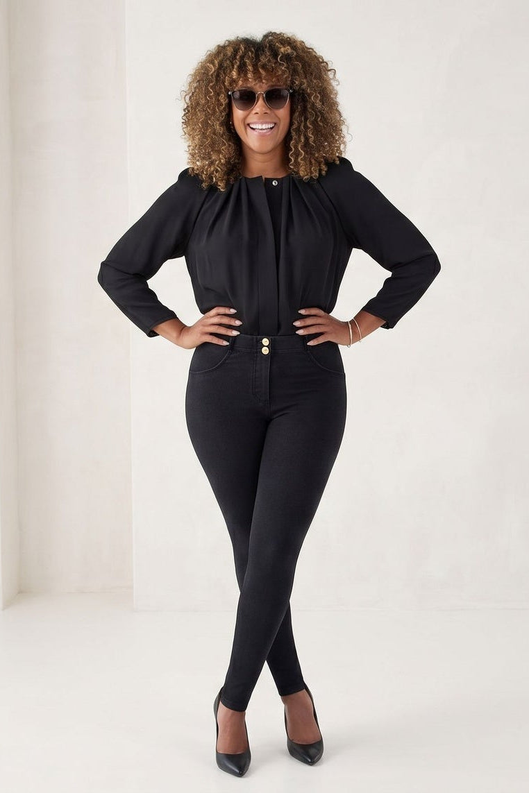 Woman wearing a black outfit with sunglasses on a white background