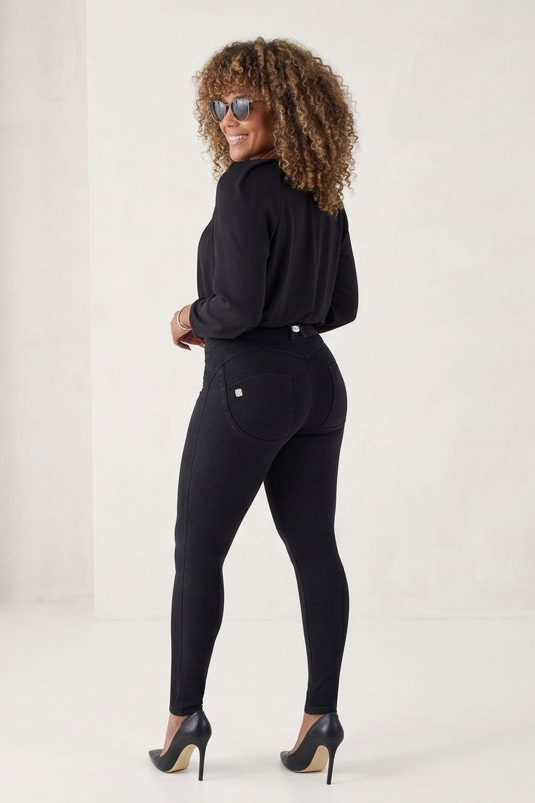 Woman wearing a black outfit with sunglasses on a white background