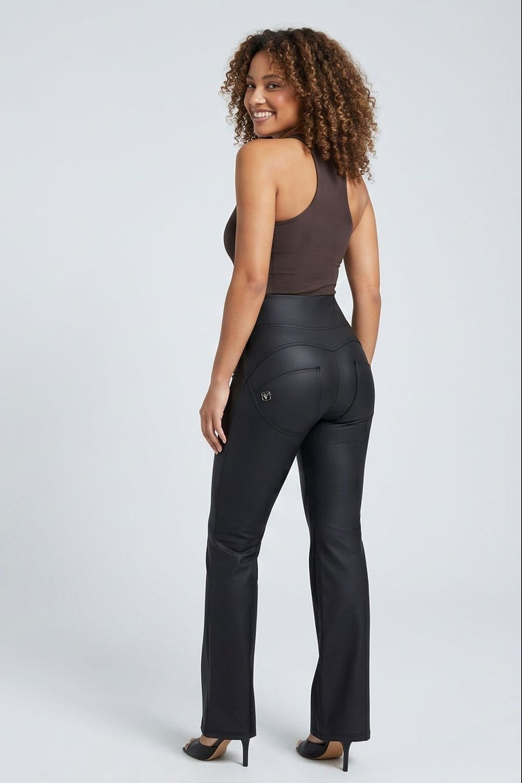 Woman modeling black leather pants from front and back on a white background