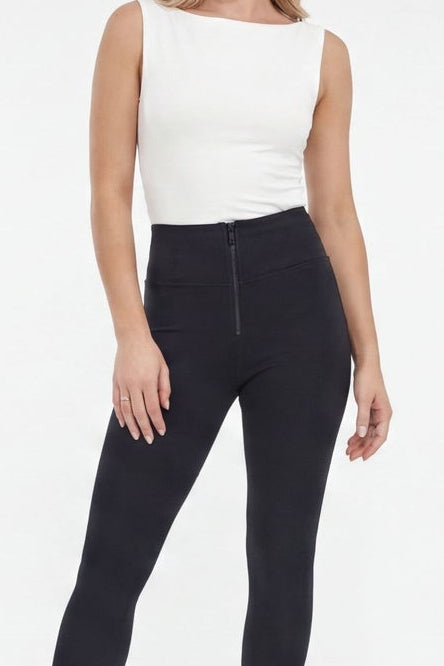 Woman wearing black leggings and a white top, shown from front and side views on a white background.