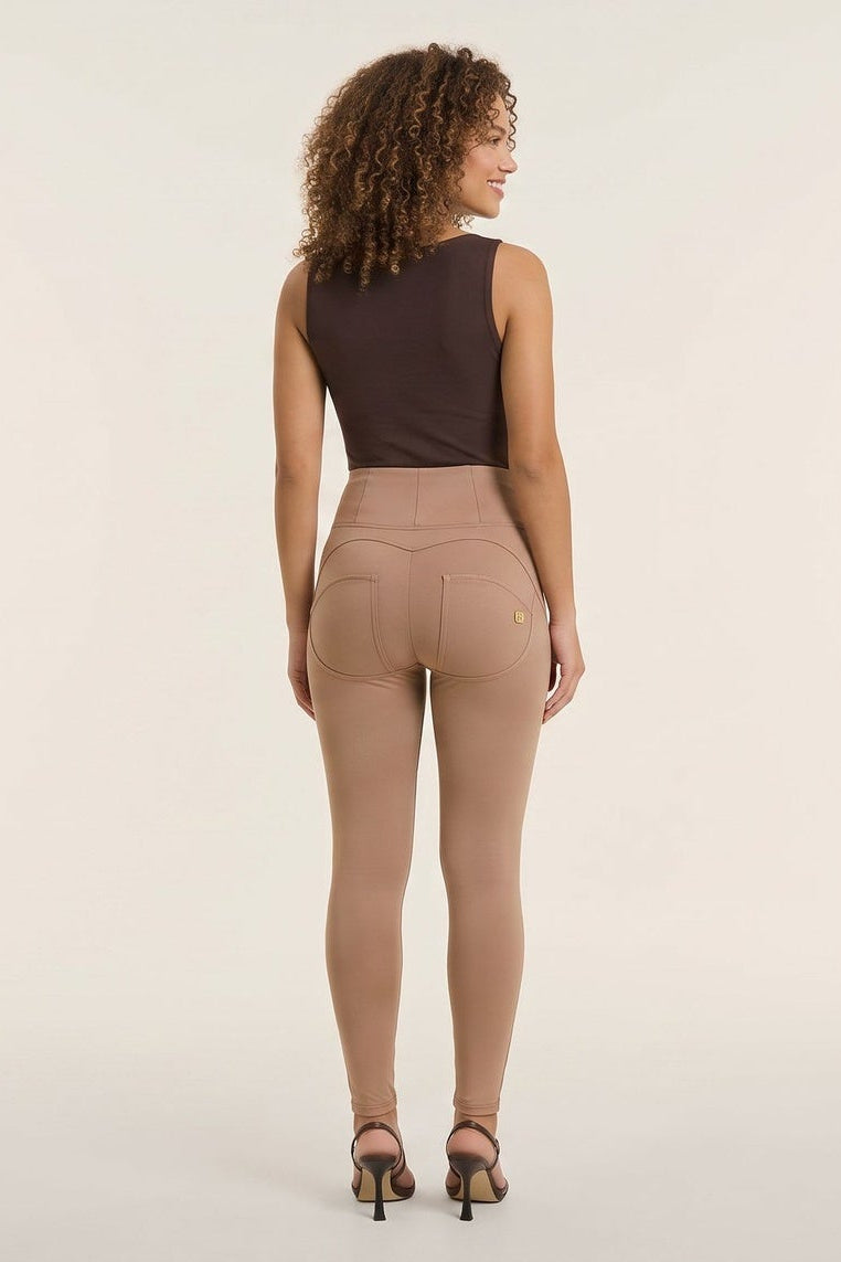 Woman wearing a brown sleeveless top and beige pants, facing front and back, on a white background.