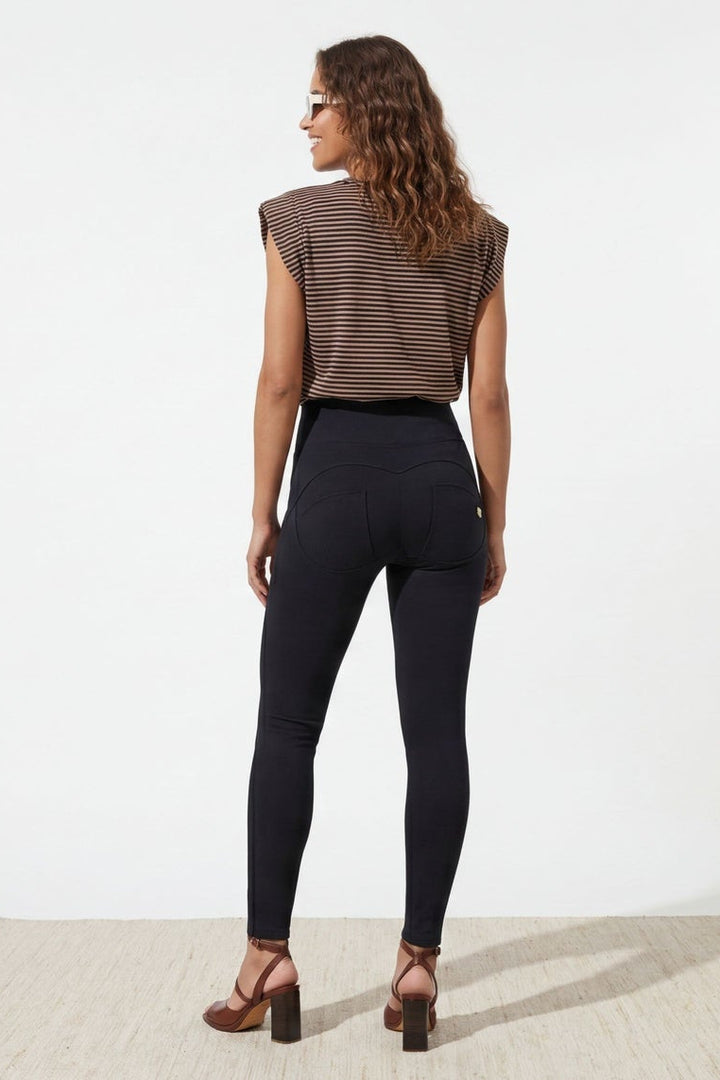 Woman wearing a brown sleeveless top and black pants, shown from front and back on a white background.
