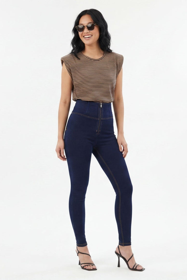Woman wearing dark blue jeans on a white background