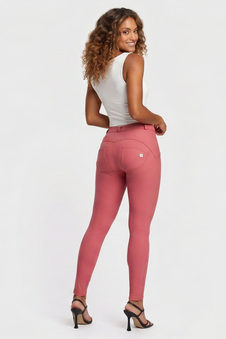 Woman wearing pink pants on a white background