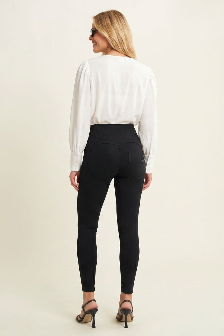 Woman wearing a white blouse and black pants, shown from front and back on a plain background