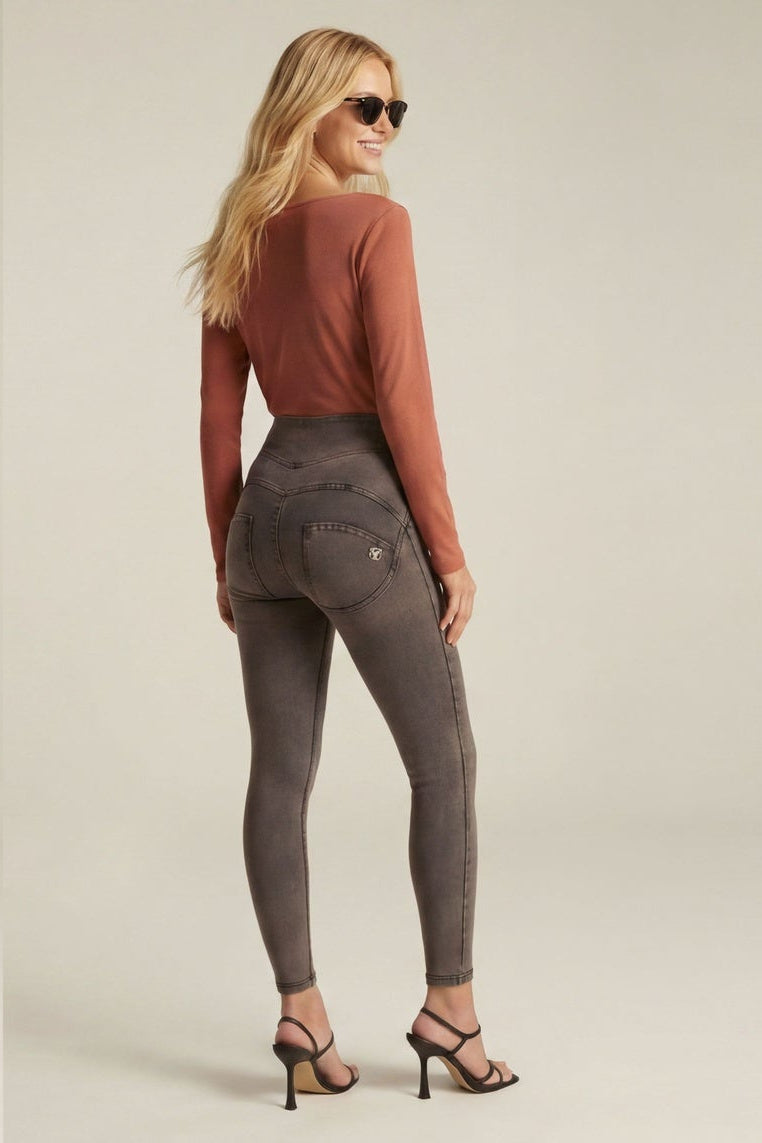 Woman wearing a rust-colored top and gray jeans, shown from front and back on a beige background.