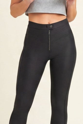 Woman wearing black leggings and a gray crop top, shown from front and back on a beige background.