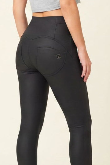 Woman wearing black leggings and a gray crop top, shown from front and back on a beige background.