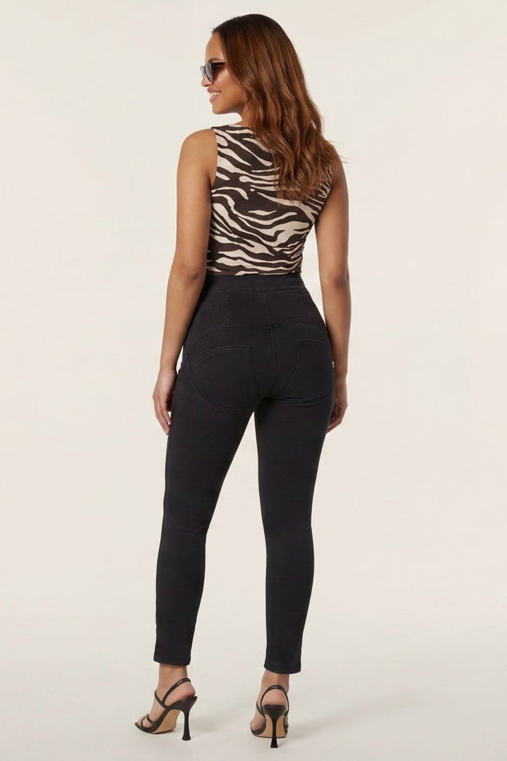 Woman wearing a zebra print top and black pants, shown from front and back on a white background.