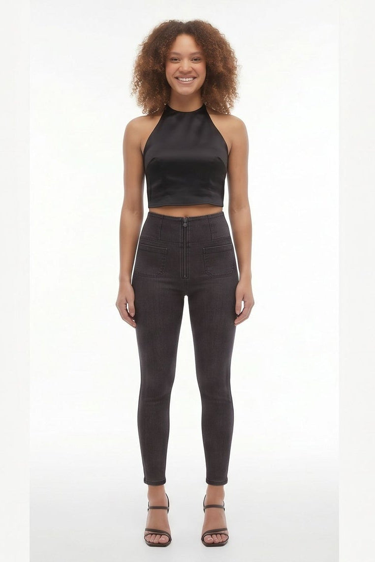 Woman wearing black sleeveless top and leggings on a white background