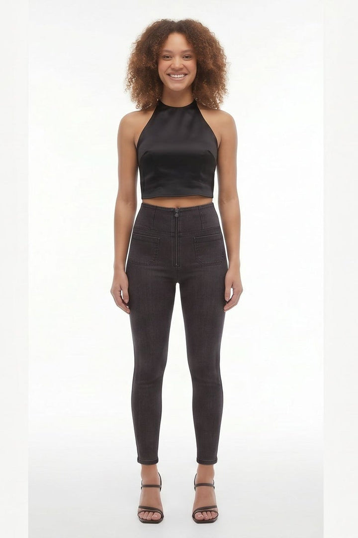 Woman wearing black sleeveless top and leggings on a white background