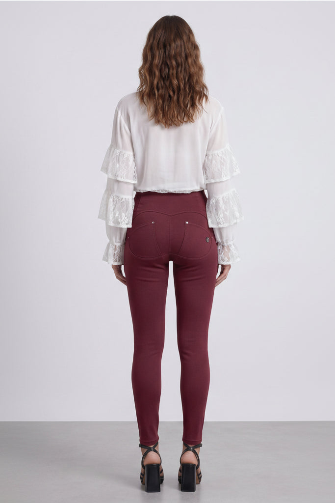 Woman wearing a white blouse and maroon pants, shown from front and back on a white background.