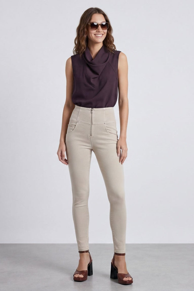 Woman wearing beige pants and a dark top, shown from front and back on a white background