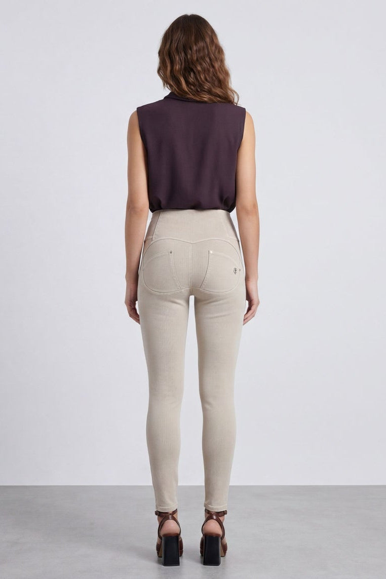 Woman wearing beige pants and a dark top, shown from front and back on a white background