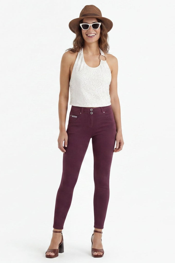 Woman wearing maroon pants and a white top in two different poses on a white background
