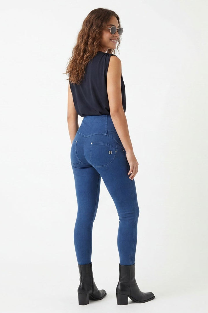 Woman wearing blue jeans and a black top, shown from front and side views on a white background.