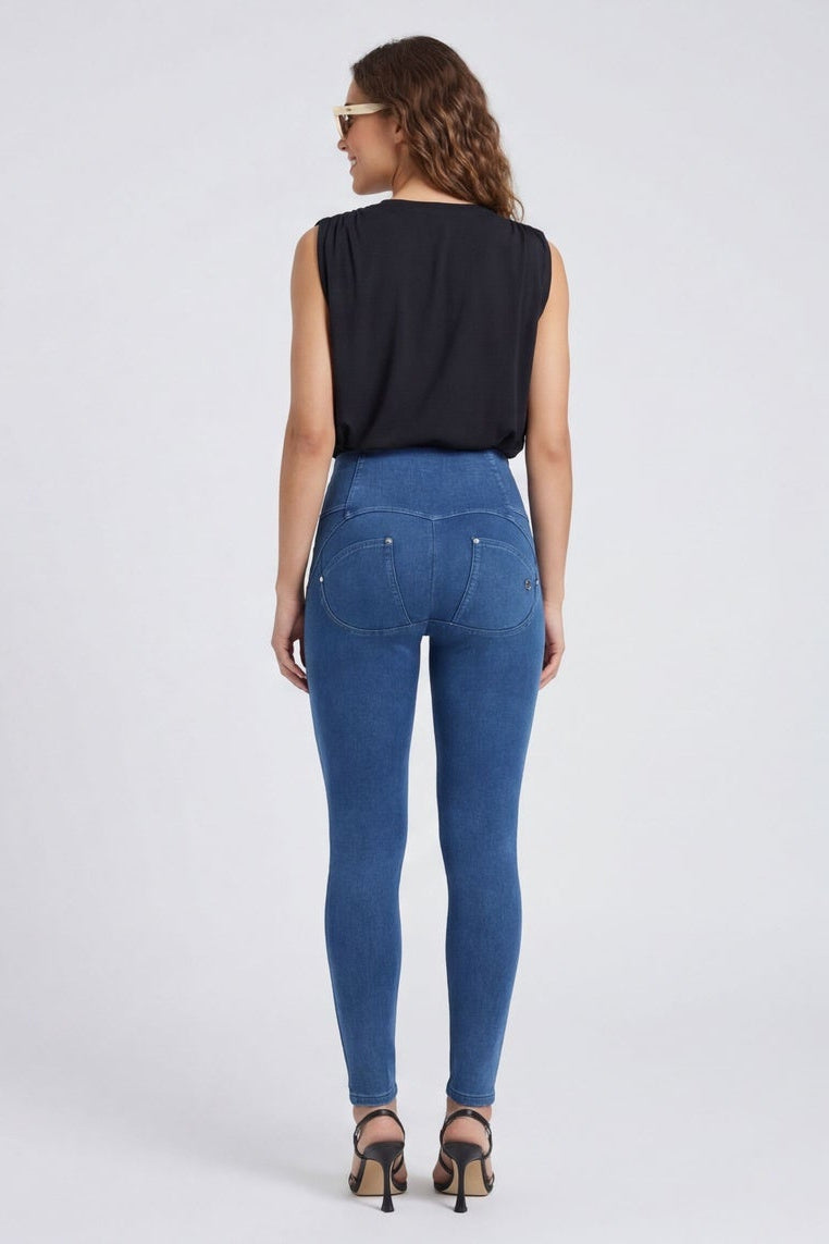 Woman wearing blue jeans and a black top, shown from front and back on a white background