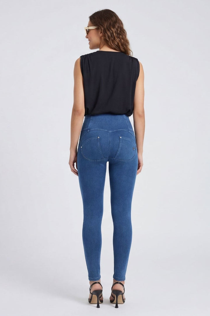 Woman wearing blue jeans and a black top, shown from front and back on a white background