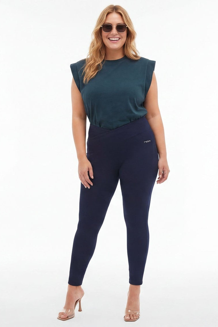 Woman wearing a teal top and navy leggings from front and back views on a white background