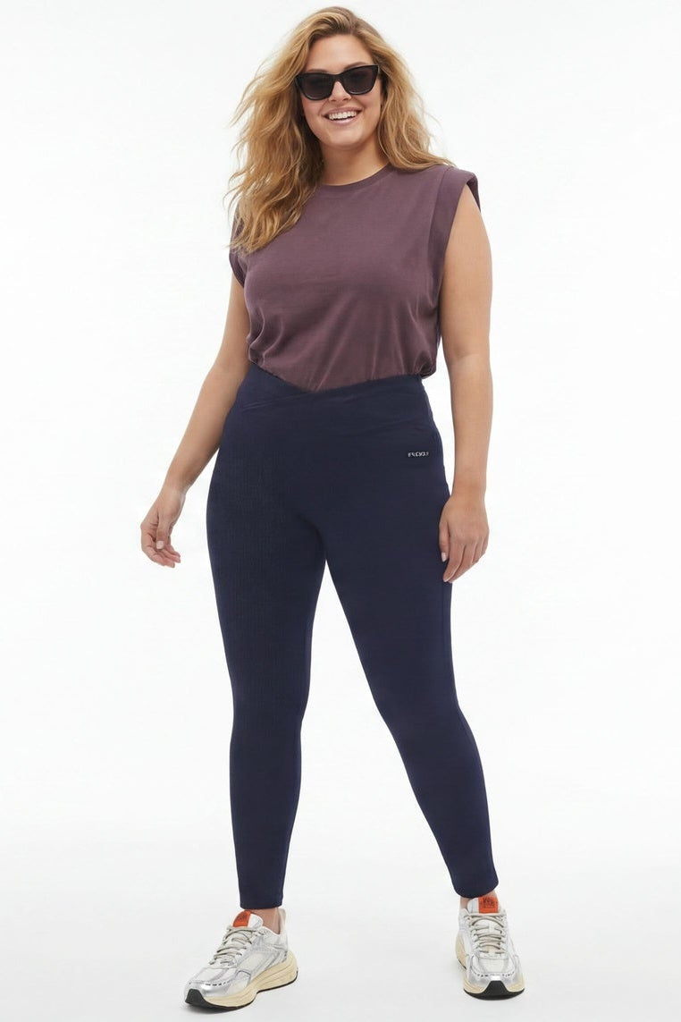 Woman wearing navy leggings and a purple top, shown from front and back on a white background.