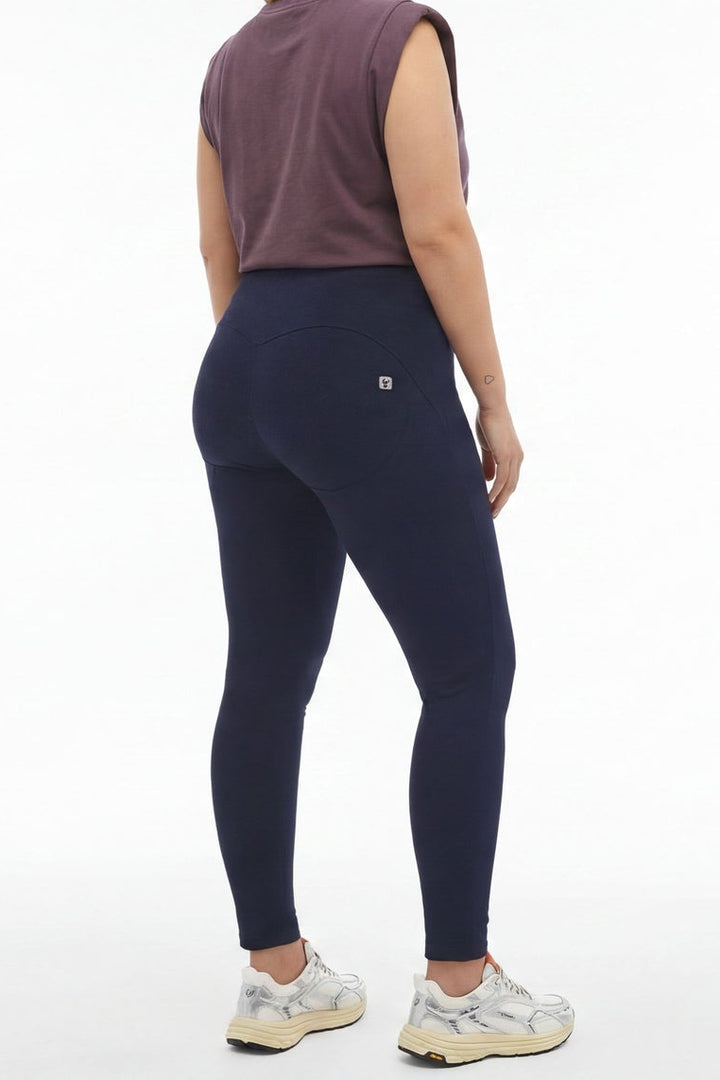 Woman wearing navy leggings and a purple top, shown from front and back on a white background.