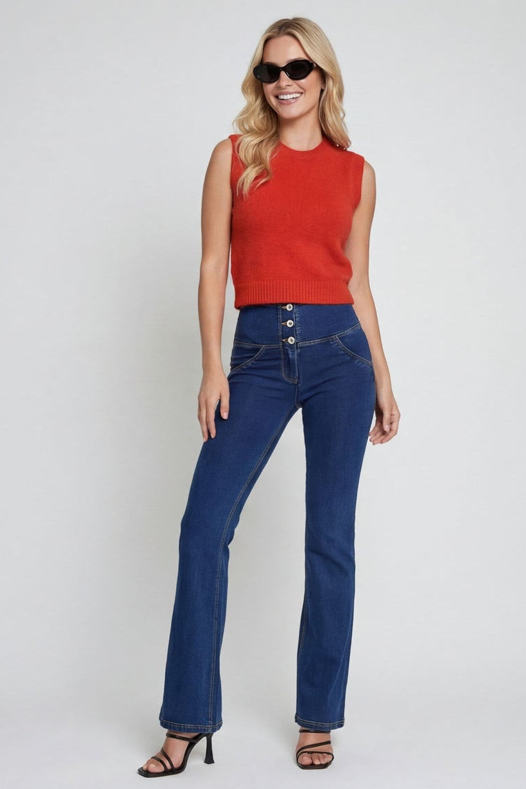 Woman wearing a red top and blue jeans on a white background